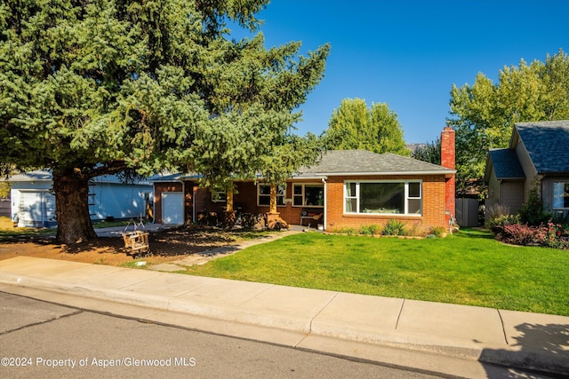 341 Park Dr, Glenwood Springs, CO 81601 - ranch-style house featuring a garage, brick siding, a front yard, and a chimney