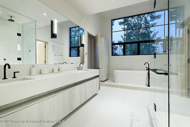 bathroom with vanity and independent shower and bath