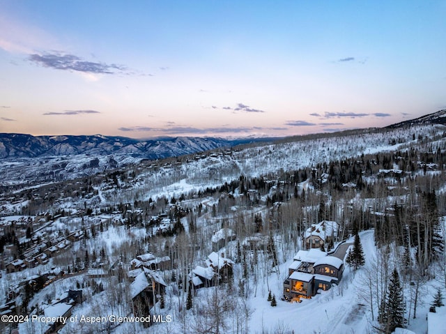 snowy aerial view with a mountain view