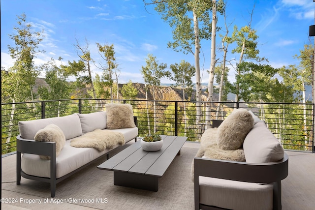 view of patio with outdoor lounge area and a balcony