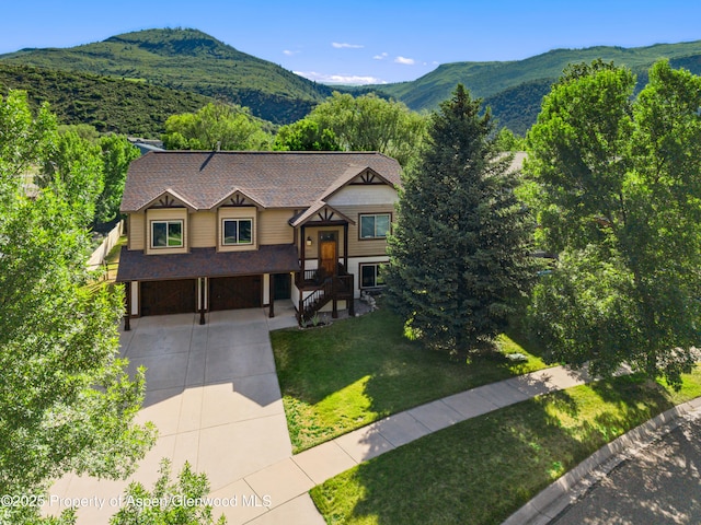 1913 Colorow Rd, Glenwood Springs, CO 81601 - bi-level home with driveway, a garage, a mountain view, a front lawn, and a shingled roof