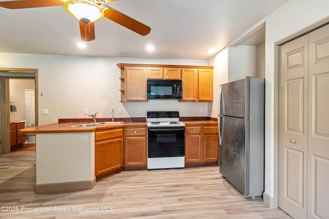 1913 Colorow Rd, Glenwood Springs, CO 81601 - kitchen with white electric stove, black microwave, freestanding refrigerator, light wood-style floors, and a ceiling fan