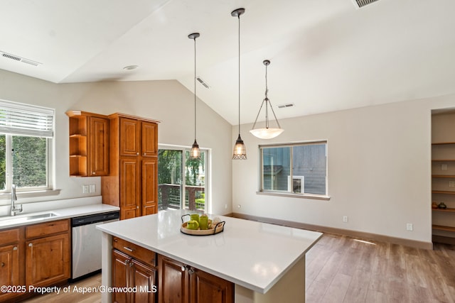 1913 Colorow Rd, Glenwood Springs, CO 81601 - kitchen with stainless steel dishwasher, vaulted ceiling, light countertops, brown cabinets, and open shelves