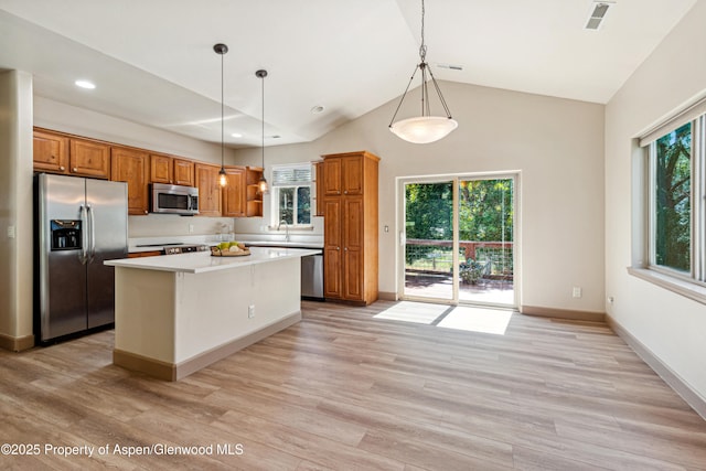 1913 Colorow Rd, Glenwood Springs, CO 81601 - kitchen featuring appliances with stainless steel finishes, brown cabinets, light countertops, a kitchen island, and recessed lighting