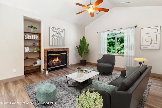 1913 Colorow Rd, Glenwood Springs, CO 81601 - living area with a ceiling fan, a tile fireplace, vaulted ceiling, and wood finished floors