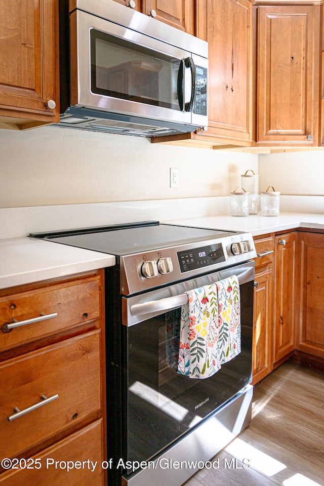 1913 Colorow Rd, Glenwood Springs, CO 81601 - kitchen with stainless steel appliances, brown cabinets, light wood-type flooring, and light countertops