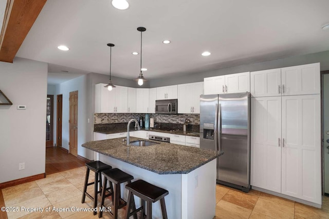 311 Sopris Cir, Basalt, CO 81621 - kitchen featuring appliances with stainless steel finishes, tasteful backsplash, recessed lighting, dark stone counters, and white cabinets