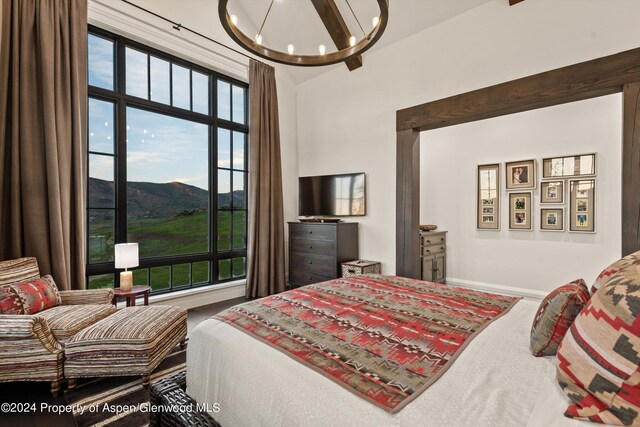 bedroom with a chandelier and baseboards