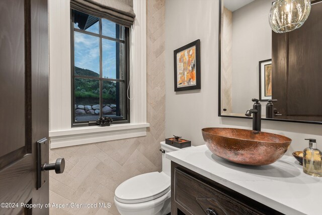 half bathroom featuring toilet and vanity