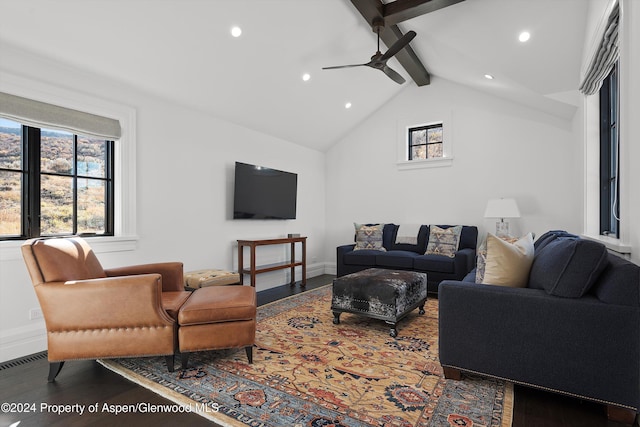 living area with baseboards, visible vents, ceiling fan, wood finished floors, and vaulted ceiling with beams