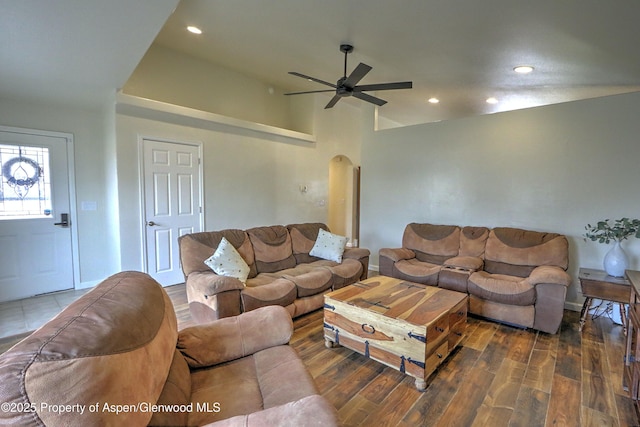 living room with dark hardwood / wood-style floors and ceiling fan