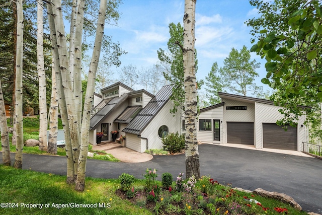 view of front of property with a garage and an outdoor structure