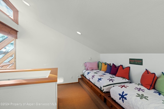 bedroom with carpet flooring and lofted ceiling