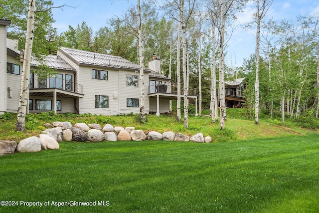 177 Stellar Ln, Snowmass Village, CO 81615 - back of property featuring a chimney, a yard, a balcony, and a metal roof