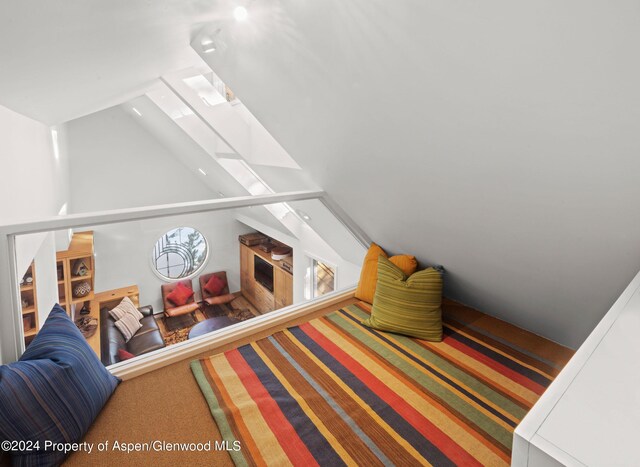 bedroom featuring carpet and vaulted ceiling