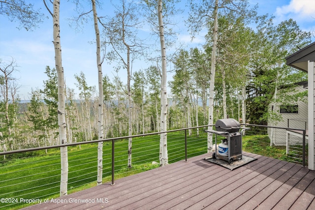 deck with a lawn and a grill