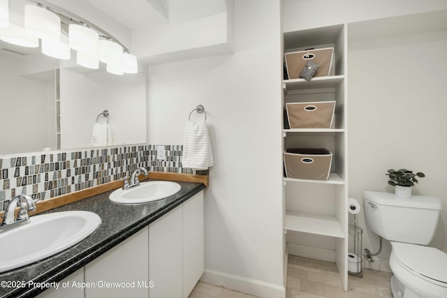 bathroom featuring backsplash, vanity, and toilet