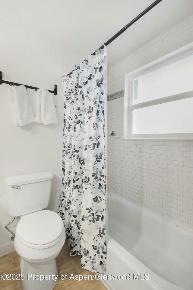 bathroom featuring toilet, shower / bath combo, and wood-type flooring