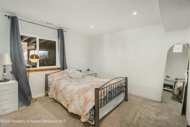 bedroom featuring light carpet