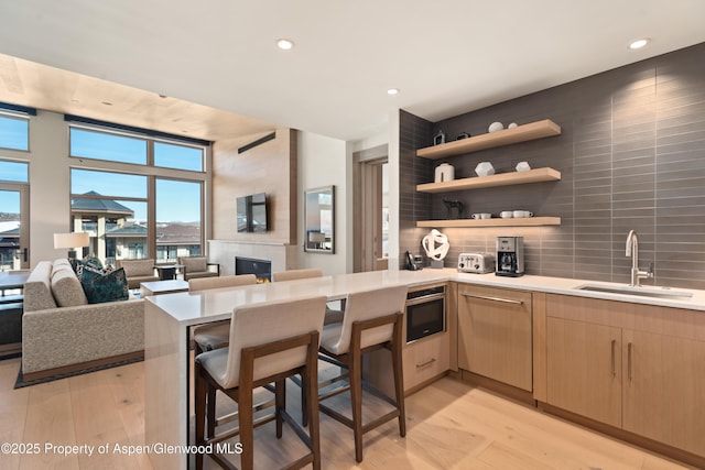 130 Wood Rd Unit 660-662, Snowmass Village, CO 81615 - kitchen with a peninsula, light countertops, light brown cabinets, light wood-style floors, and recessed lighting