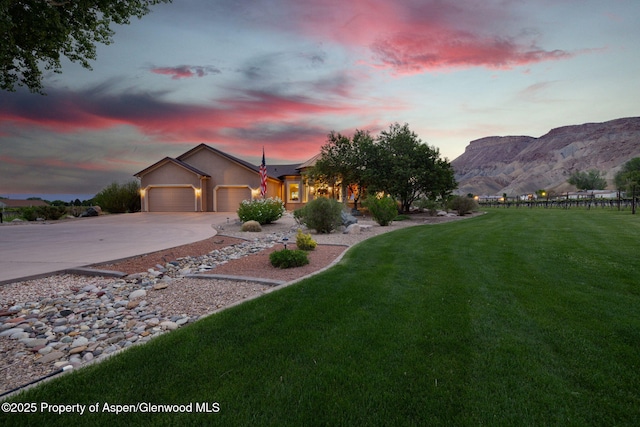 759 36 3/10 Rd, Palisade, CO 81526 - view of front facade with an attached garage, concrete driveway, a mountain view, and stucco siding