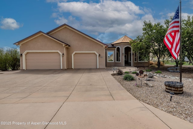 759 36 3/10 Rd, Palisade, CO 81526 - mediterranean / spanish-style house featuring stucco siding, a garage, driveway, a standing seam roof, and metal roof