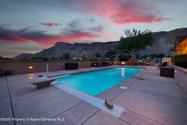 759 36 3/10 Rd, Palisade, CO 81526 - view of swimming pool featuring a patio area, a mountain view, and a diving board