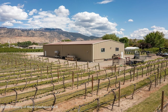 759 36 3/10 Rd, Palisade, CO 81526 - view of home's exterior featuring a pole building, an outdoor structure, a mountain view, a rural view, and fence