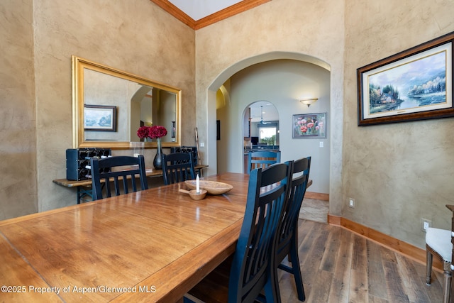 759 36 3/10 Rd, Palisade, CO 81526 - dining room with arched walkways, wood finished floors, crown molding, and baseboards
