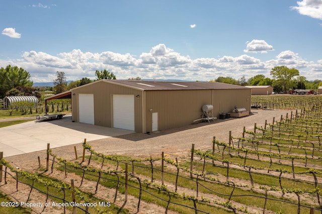 759 36 3/10 Rd, Palisade, CO 81526 - view of property exterior with fence, a detached garage, and an outbuilding