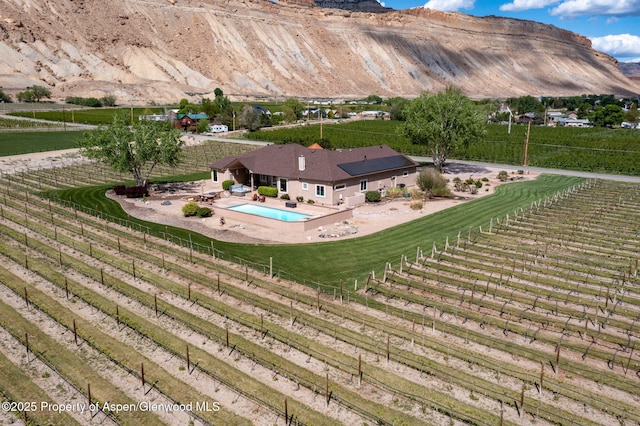 759 36 3/10 Rd, Palisade, CO 81526 - view of rural area featuring a pool, abundant farmland, and a mountainous background