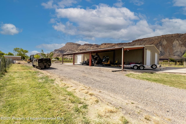 759 36 3/10 Rd, Palisade, CO 81526 - view of front of home with a mountain view, a pole building, an outdoor structure, and a front yard