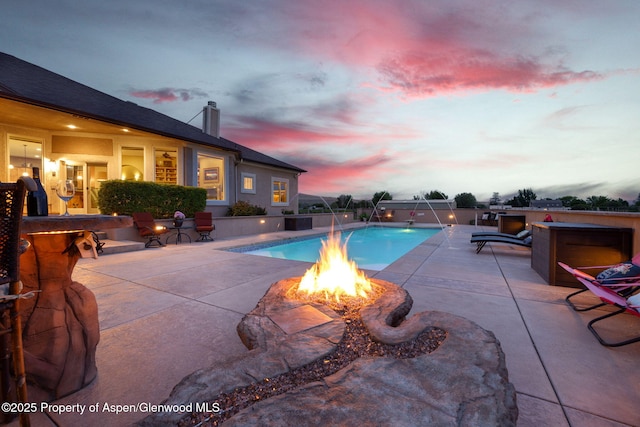 759 36 3/10 Rd, Palisade, CO 81526 - pool at dusk featuring a fire pit and a patio area