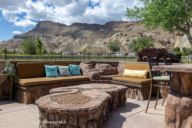 759 36 3/10 Rd, Palisade, CO 81526 - view of patio featuring fence, a mountain view, and an outdoor fire pit