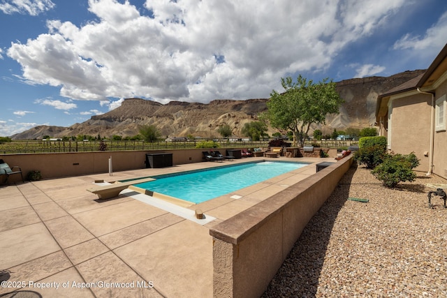 759 36 3/10 Rd, Palisade, CO 81526 - view of swimming pool with a mountain view, a patio, a diving board, and fence