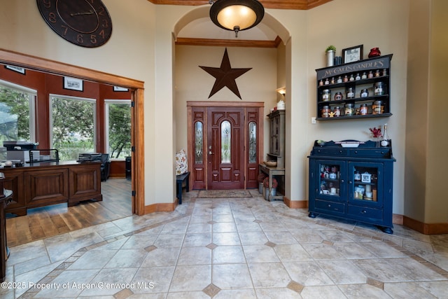 759 36 3/10 Rd, Palisade, CO 81526 - foyer featuring crown molding, a high ceiling, baseboards, healthy amount of natural light, and arched walkways