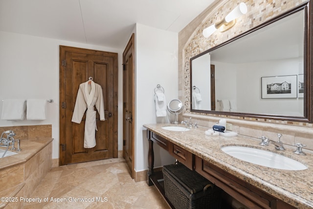 bathroom featuring vanity and tiled bath