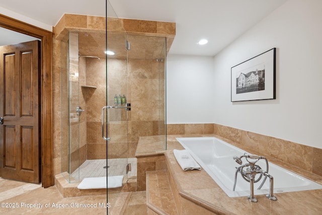 bathroom featuring independent shower and bath