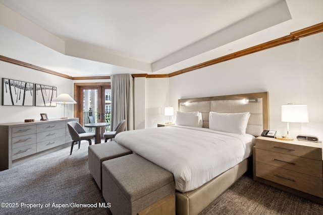 carpeted bedroom with ornamental molding, access to exterior, and a raised ceiling