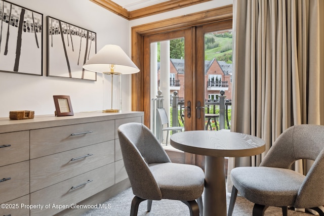 dining area with crown molding and french doors