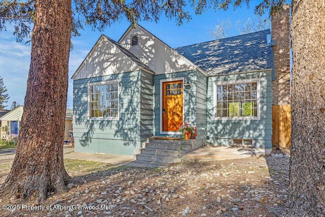 828 Taylor St, Craig, CO 81625 - view of front of home featuring entry steps, roof with shingles, and a chimney