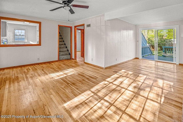 828 Taylor St, Craig, CO 81625 - unfurnished room featuring hardwood / wood-style floors, baseboards, ceiling fan, stairs, and vaulted ceiling