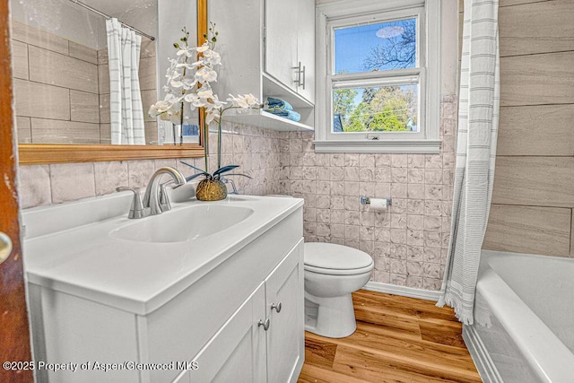 828 Taylor St, Craig, CO 81625 - bathroom with vanity, toilet, wood finished floors, and shower / bath combo