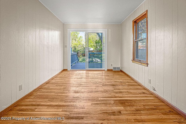 828 Taylor St, Craig, CO 81625 - empty room featuring wood finished floors and wood walls