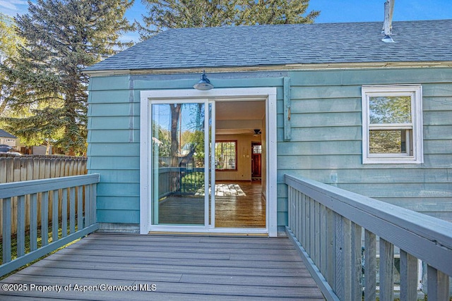 828 Taylor St, Craig, CO 81625 - view of exterior entry featuring a shingled roof and a wooden deck