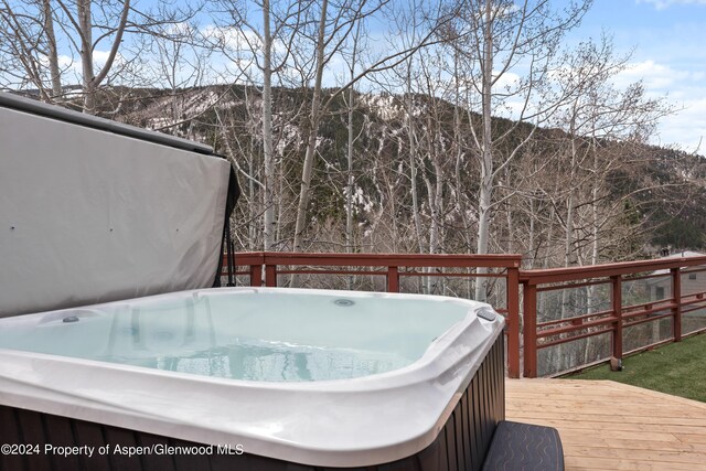 wooden terrace featuring a hot tub