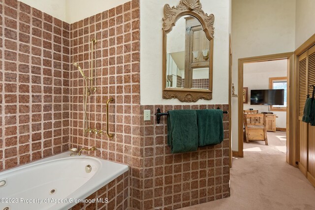 bathroom featuring a relaxing tiled tub