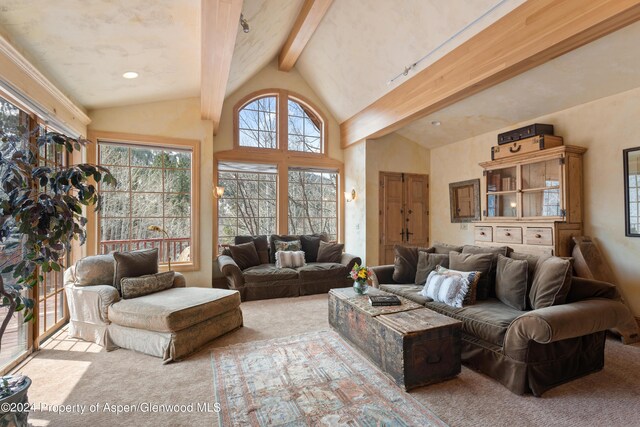 carpeted living room featuring lofted ceiling with beams