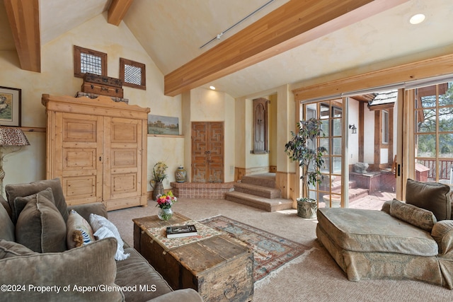 living room featuring beamed ceiling, carpet floors, and a wealth of natural light