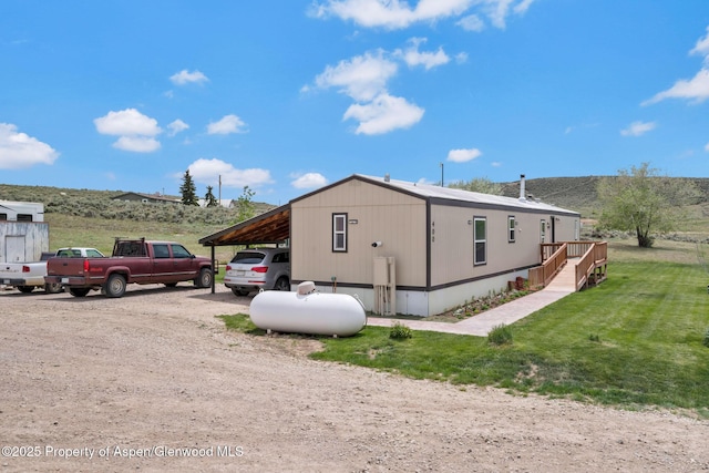 400 Behrman St, Craig, CO 81625 - view of side of property featuring a lawn and driveway